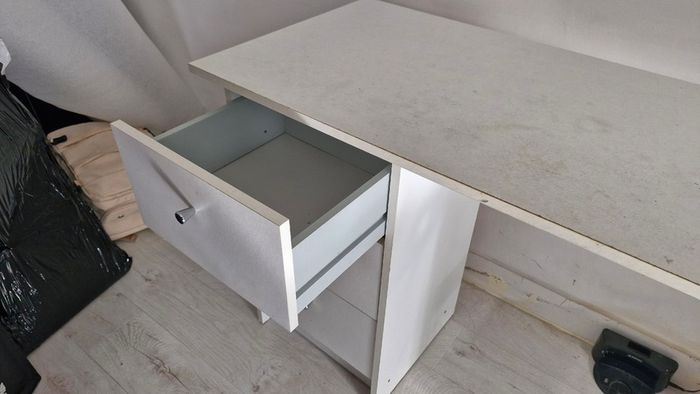 White desk with three drawers and side shelving