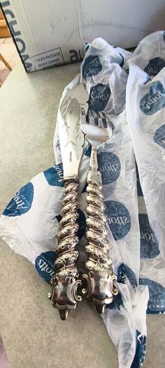 Silver-plated utensil fish carving set or serving set, noted by the specific shape of the knife blade.