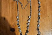 This matching silver-tone crystal necklace and bracelet set features alternating clear and black round stations with textured bezels.  SEE PHOTOS FOR SAME.