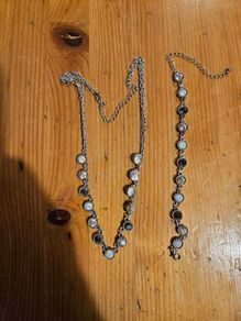 This matching silver-tone crystal necklace and bracelet set features alternating clear and black round stations with textured bezels.  SEE PHOTOS FOR SAME.