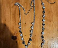 This matching silver-tone crystal necklace and bracelet set features alternating clear and black round stations with textured bezels.  SEE PHOTOS FOR SAME.