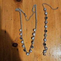 This matching silver-tone crystal necklace and bracelet set features alternating clear and black round stations with textured bezels.  SEE PHOTOS FOR SAME.
