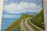 picture This piece depicts a railway line sweeping around a coastal bay beneath a footbridge and hillsides, signed Brian Davies in the lower left corner.