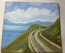 picture This piece depicts a railway line sweeping around a coastal bay beneath a footbridge and hillsides, signed Brian Davies in the lower left corner.