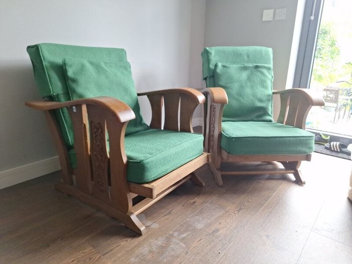 Pair of green arm chairs.