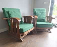 Pair of green arm chairs.