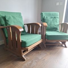 Pair of green arm chairs.