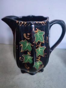Victorian pottery pitcher. Gloss black glazed pitcher with ivy leaf design in green