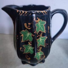 Victorian pottery pitcher. Gloss black glazed pitcher with ivy leaf design in green