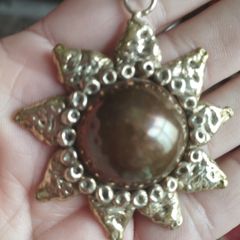 Vintage pendant on a long chain.