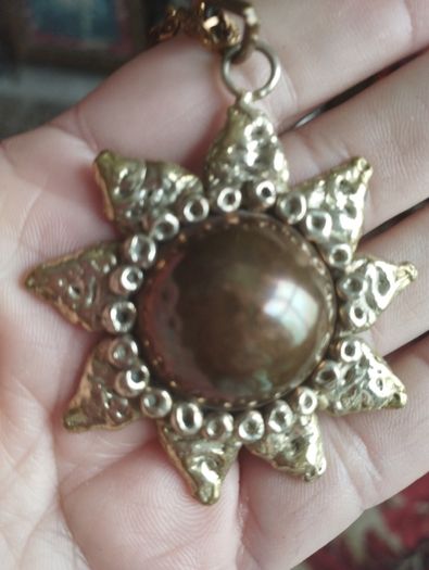 Vintage pendant on a long chain.