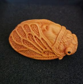 Carved wooden cicada.