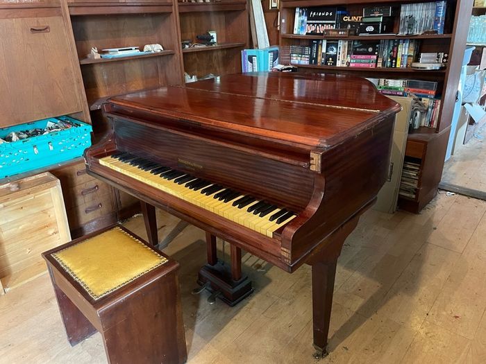 a circa-1931 Monington & Weston baby grand with matching stool.