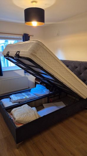 King size ottoman storage bed with navy velvet headboard