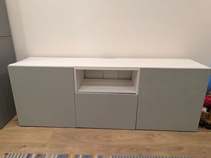 White TV unit with grey-green doors