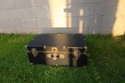 Black storage trunk with red patterned lining
