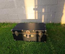Black storage trunk with red patterned lining