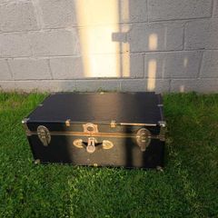 Black storage trunk with red patterned lining