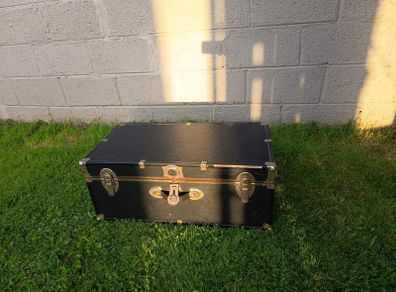 Black storage trunk with red patterned lining