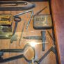vintage shadow box containing a mix of antique tools, keys, and a loom. Image 4