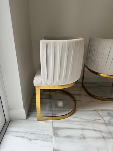 Cream and gold armchairs