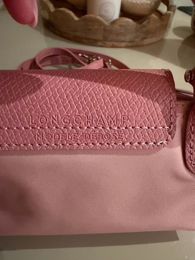 pink Longchamp Le Pliage mini top-handle bag with a detachable shoulder strap