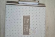 Baby record book and silver rattle