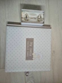 Baby record book and silver rattle