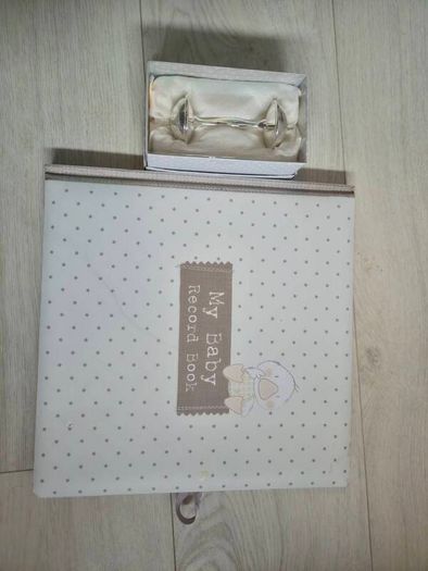 Baby record book and silver rattle
