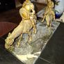 Rare Don Quixote and Sancho Panza cast in patinated bronze and mounted onto a veined marble plinth base. Don Quixote is depicted atop his gaunt horse, Rocinante, holding his shield, while his squire Sancho Panza follows Image 5