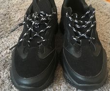 Black trainers bought in Boutique in London