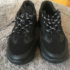 Black trainers bought in Boutique in London