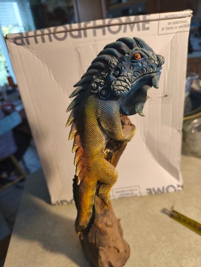 handmade iguana on natural wood log