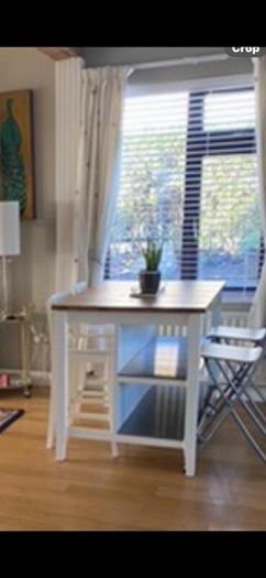 IKEA Free-standing kitchen island with foldable chairs.