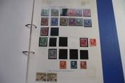 A collection of stamps from various countries on pages in binder (1872-2000s)