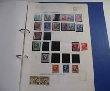 A collection of stamps from various countries on pages in binder (1872-2000s)