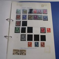 A collection of stamps from various countries on pages in binder (1872-2000s)