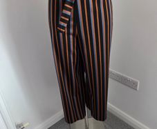 New. Size XL. Fits 10 to 14. Pieces wide leg belted striped trousers.