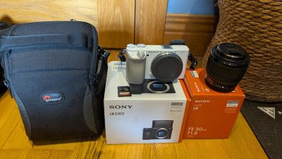 White Sony A6100 + Sony 50mm F1.8 Lens, Lowepro Bag & SD Card