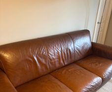 brown leather couch and chair