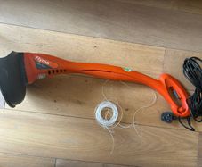 Flymo electric strimmer with extra strimming wire .