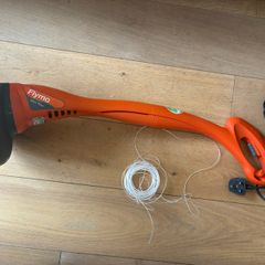 Flymo electric strimmer with extra strimming wire .
