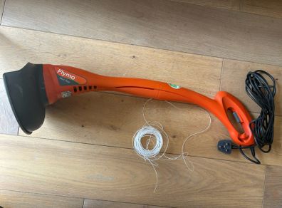 Flymo electric strimmer with extra strimming wire .