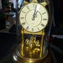 West Germany Estyma Anniversary Clock, featuring a brass finish and a rotating pendulum under a Glass Dome, Image 2