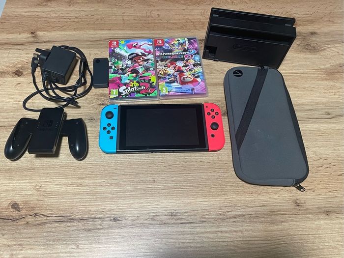 Nitendo switch, including 2 games, splatoon 2 & Mario kart deluxe and accessories too.