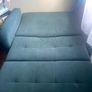 Grey fabric sofa bed with large storage compartment. Image 6