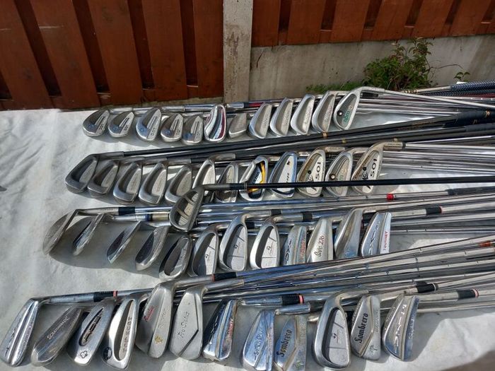 A selection of Golf clubs. Bags and golf balls.