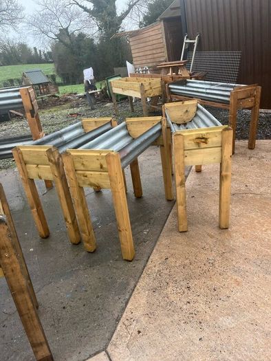 Raised beds bird feeders and cast iron benches