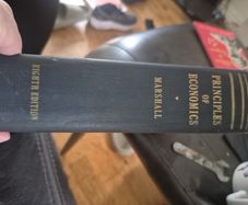 An original hardcover printing of Alfred Marshalls Principles of Economics eighth Edition published by Macmillan