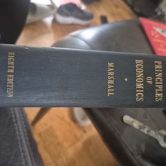 An original hardcover printing of Alfred Marshalls Principles of Economics eighth Edition published by Macmillan